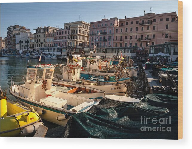 Anzio Wood Print featuring the photograph small working fishing boats moored stern first in Anzio harbour by Peter Noyce