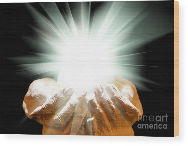 Spiritual Wood Print featuring the photograph Spiritual light in cupped hands on a black background by Simon Bratt