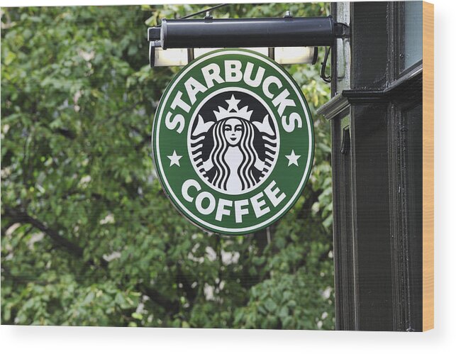 Hanging Wood Print featuring the photograph Starbucks coffee sign hanging outside a shop by JohnFScott