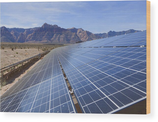 Scenics Wood Print featuring the photograph Tilted solar panels, near the mountains of the Mojave Desert by Andreiorlov
