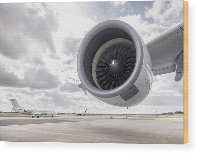 England Wood Print featuring the photograph View of A380 aircraft jet engine and planes on runway by Monty Rakusen