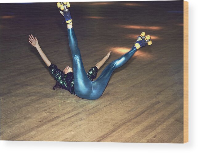 Youth Culture Wood Print featuring the photograph Woman having fun at roller disco by Flashpop