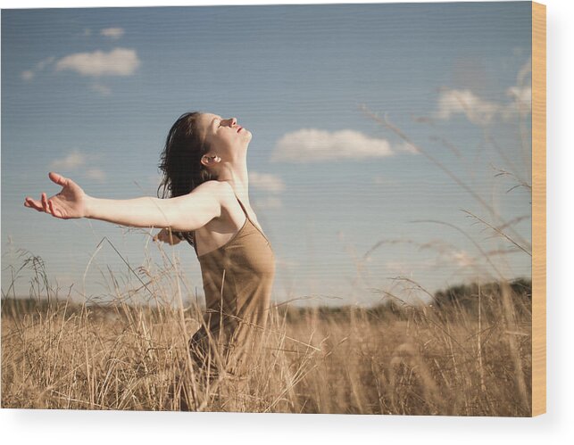 Wind Wood Print featuring the photograph Woman standing in long grass by LiFE on Manual