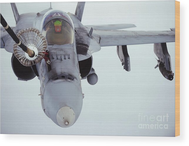 Kc-10 Extender Wood Print featuring the photograph An Fa-18 Super Hornet Receives Fuel by Stocktrek Images