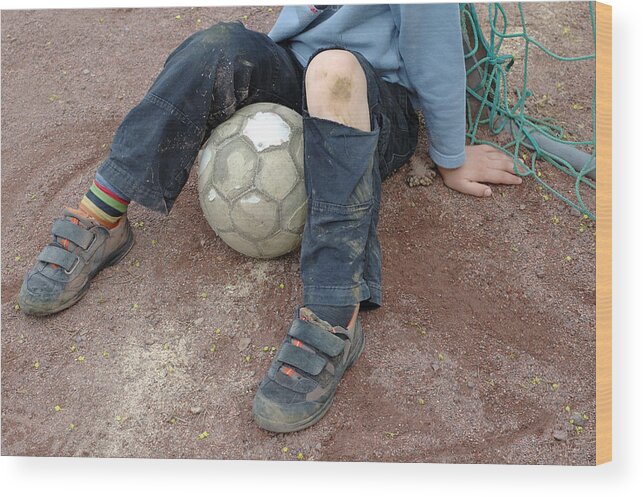 Ball Wood Print featuring the photograph Boy with soccer ball sitting on dirty field by Matthias Hauser