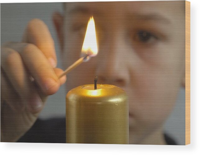 Boy Wood Print featuring the photograph Child lights a candle by Matthias Hauser