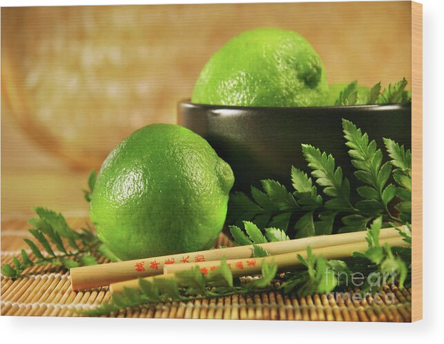 Asian Wood Print featuring the photograph Limes with chopsticks by Sandra Cunningham