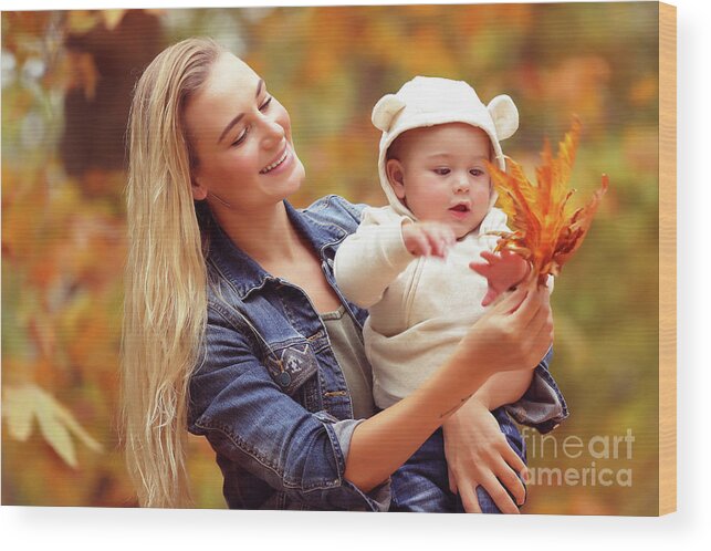 Autumn Wood Print featuring the photograph Mother with son enjoying autumn #1 by Anna Om