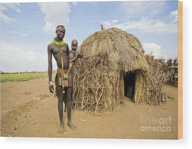 Nyangatom Wood Print featuring the photograph Nyangatom woman with baby in arms #1 by Eyal Bartov