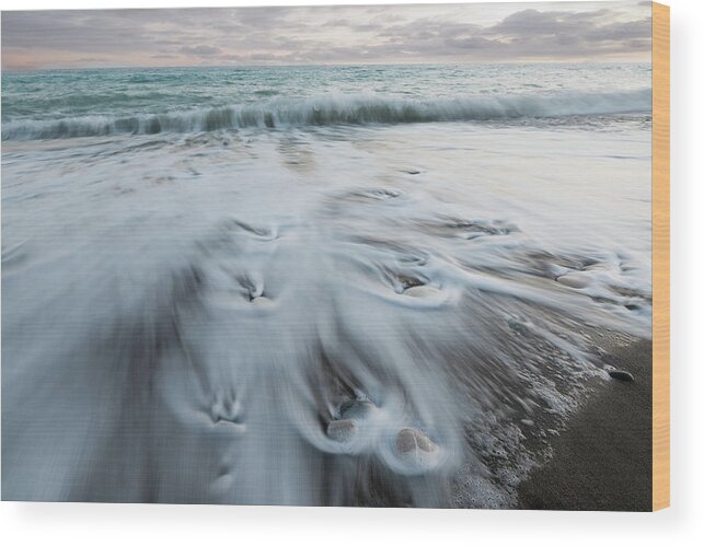 Coastline Wood Print featuring the photograph Pebbles in the beach and flowing sea water by Michalakis Ppalis