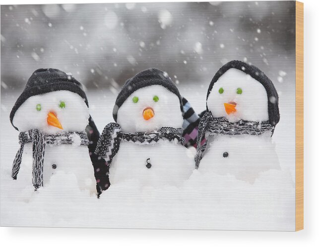 Christmas Wood Print featuring the photograph Three cute snowmen #1 by Simon Bratt