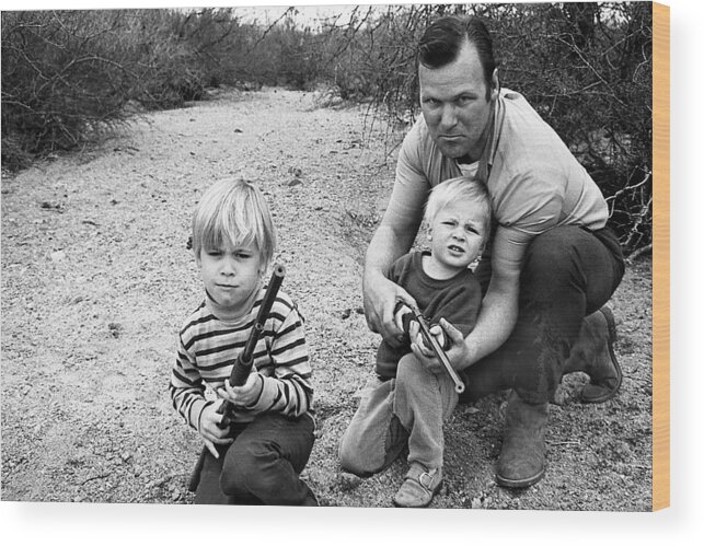 Barry Sadler Instructing Sons Shooting With Toy Rifles Tucson Arizona 1971 Wood Print featuring the photograph Barry Sadler instructing sons shooting with toy rifles Tucson Arizona 1971 by David Lee Guss