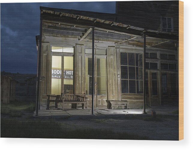 Abandoned Wood Print featuring the photograph Bodie Hotel illuminated at night by Karen Foley