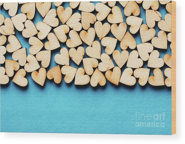 Love Wood Print featuring the photograph Bunch of hearts on blue background. by Michal Bednarek