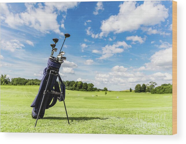 Golf Wood Print featuring the photograph Golf equipment bag standing on a course. by Michal Bednarek