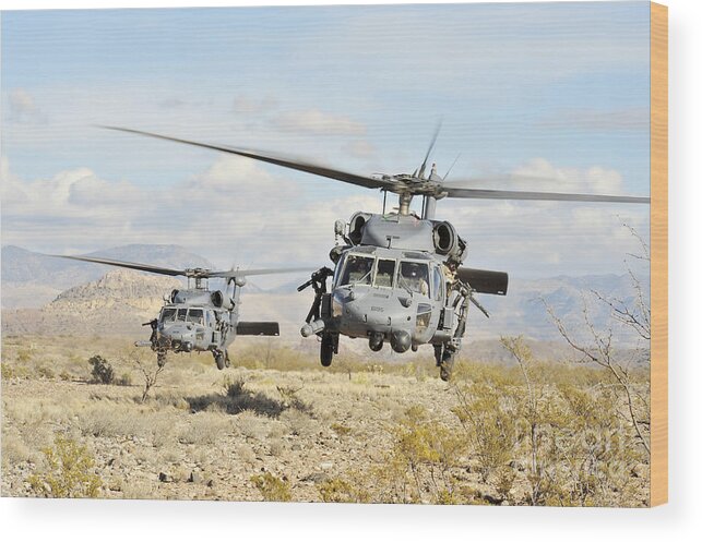 Military Wood Print featuring the photograph Hh-60g Pave Hawk Helicopters Land by Stocktrek Images
