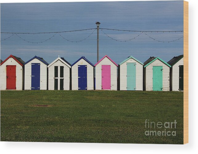 Beach Huts Wood Print featuring the photograph Holiday beach huts by Tom Conway