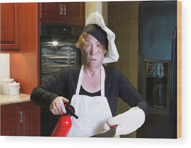 Burning Wood Print featuring the photograph Kichen disaster in apron with fire extinguisher and pan by Karen Foley