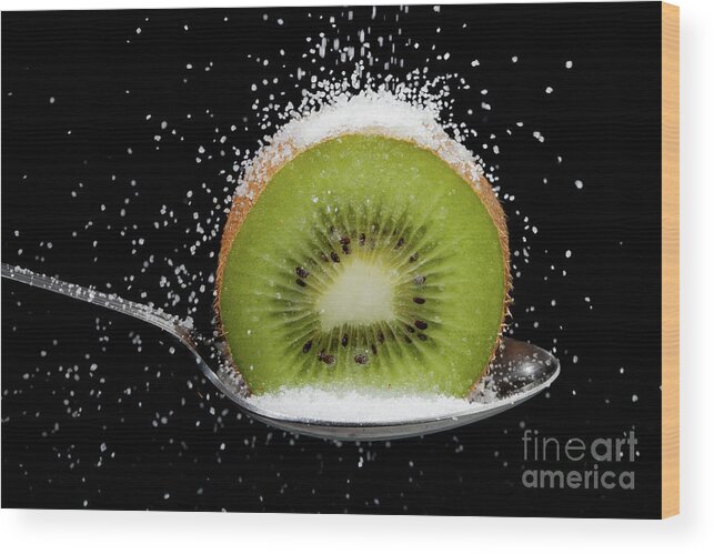 Kiwi Wood Print featuring the photograph Kiwi fruit cut in half on a spoon with sugar by Simon Bratt