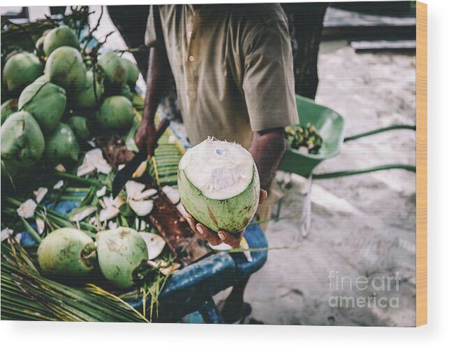 Man Wood Print featuring the photograph Man handing in a green coconut. Traditional local agriculture. by Michal Bednarek