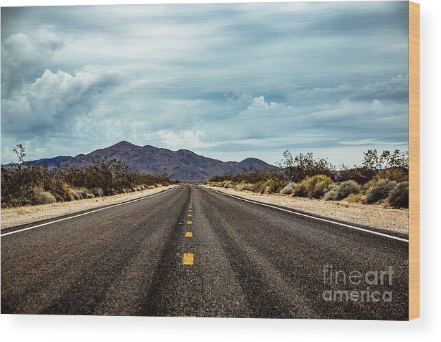 Car Wood Print featuring the photograph Straight road with mountains in the background and clouds by Amanda Mohler