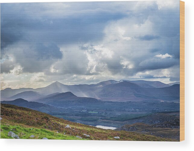 Blackvalley Wood Print featuring the photograph Sun rays piercing through the clouds touching the Irish landscap by Semmick Photo