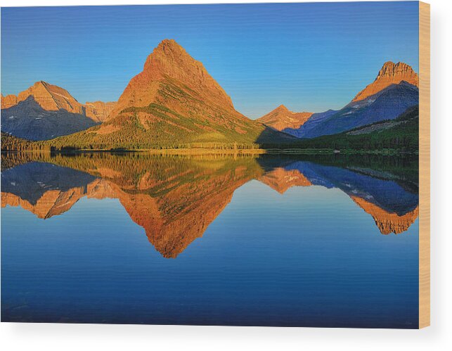 Swiftcurrent Lake Wood Print featuring the photograph Swiftcurrent Morning Reflections by Greg Norrell