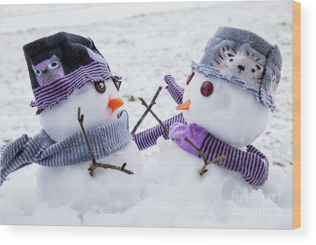 Snowmen Wood Print featuring the photograph Two cute snowmen friends embracing by Simon Bratt