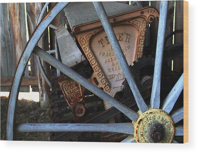 Wagon Wood Print featuring the photograph Wagon Wheel and Grass Seeder by Joanne Coyle