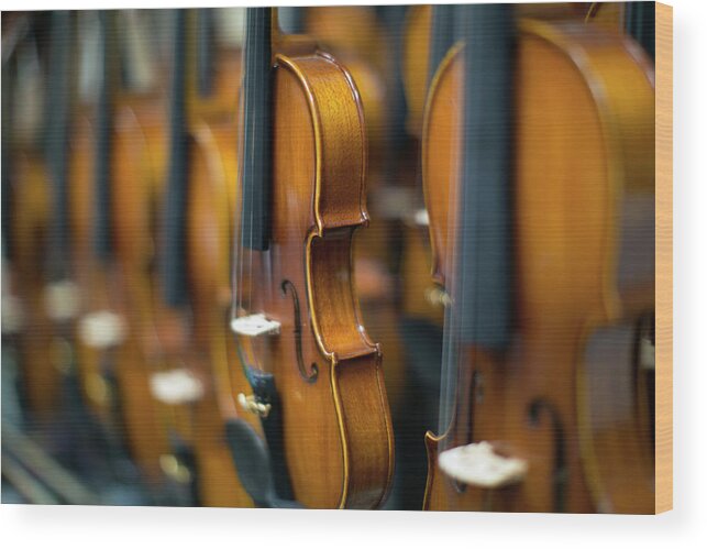 Music Wood Print featuring the photograph Violins In A Row In A Shop #1 by Eternity In An Instant