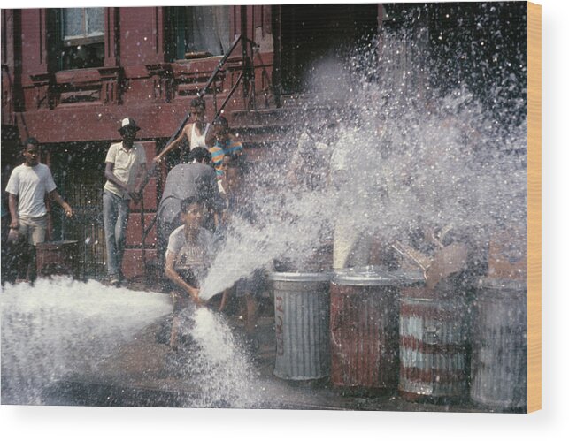 Photography Wood Print featuring the photograph 1980s Kid At Open Fire Hydrant Making by Vintage Images