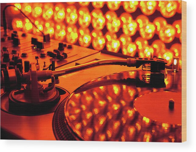 Orange Color Wood Print featuring the photograph A Turntable And Sound Mixer Illuminated by Twins