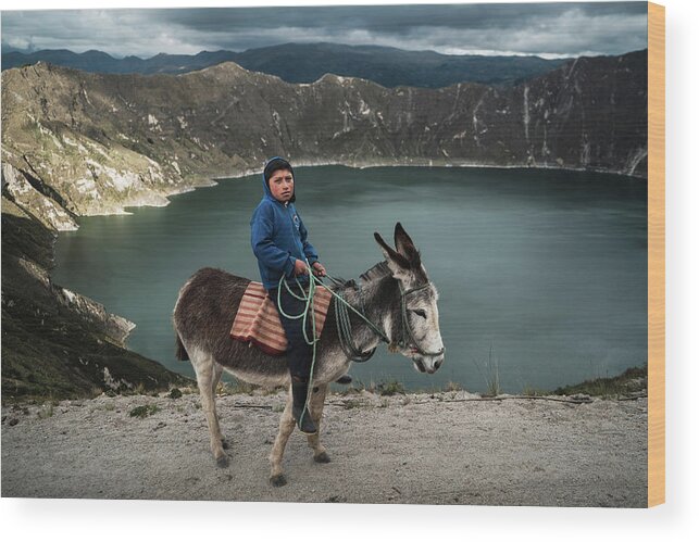 2017 Wood Print featuring the photograph A young indigenous boy with his donkey at Quilotoa Lake in Ecuador by Kamran Ali