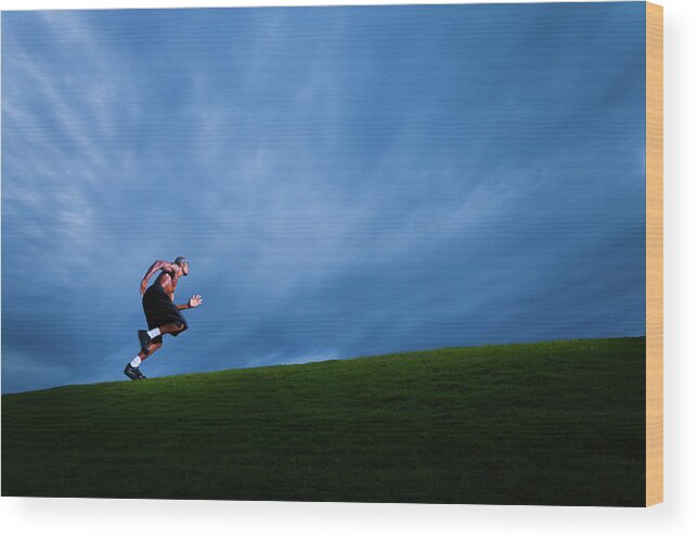 Expertise Wood Print featuring the photograph Athlete Running Up Grassy Hill by Johnnyhetfield