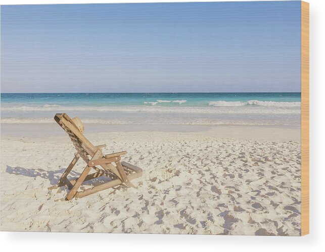 Tranquility Wood Print featuring the photograph Beach Chair With Hat On Beach Next To by Sasha Weleber