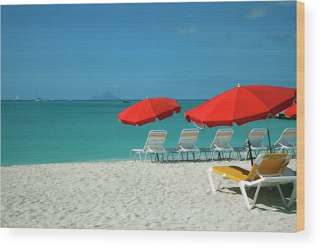 In A Row Wood Print featuring the photograph Beach Sun Loungers And Sunshades by Onfilm