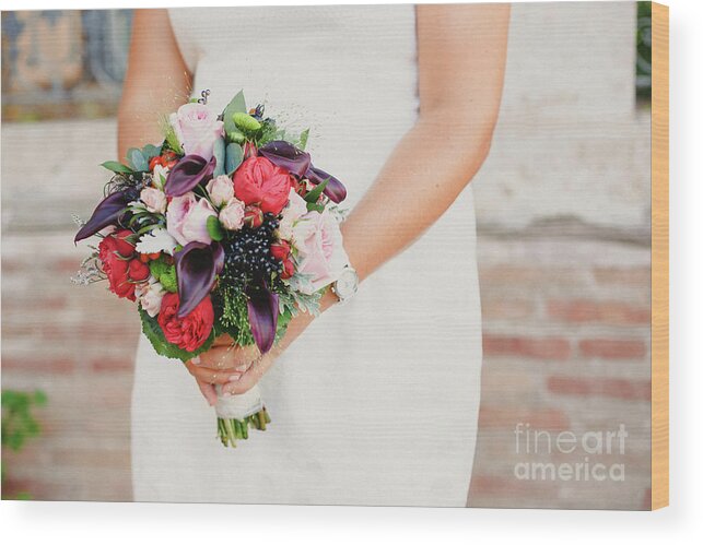 Arrangement Wood Print featuring the photograph Bridal bouquet held by her with her hands at her wedding by Joaquin Corbalan