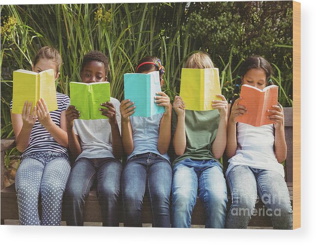 Three Quarter Length Wood Print featuring the photograph Children Reading Books At Park by Wavebreakmedia