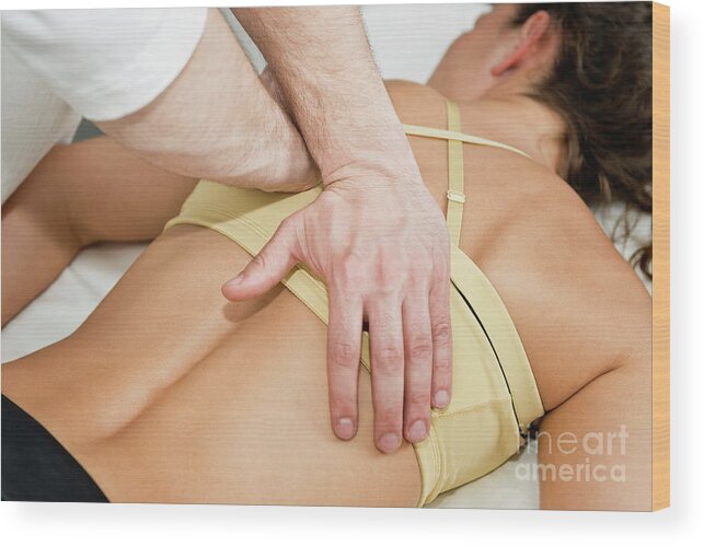 Lying Down Wood Print featuring the photograph Chiropractor Treating Patient by Microgen Images/science Photo Library