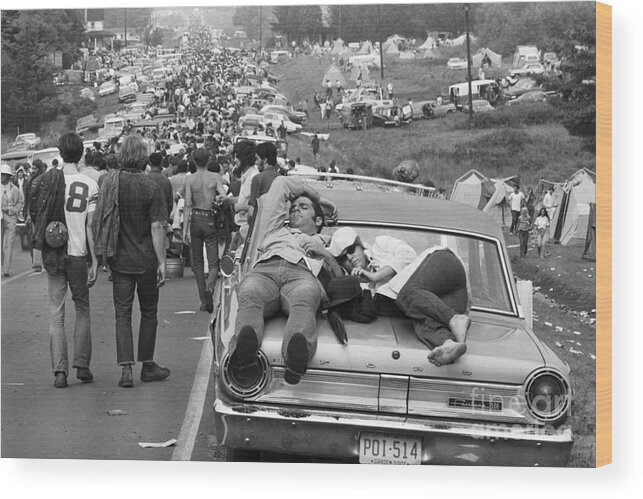 Crowd Of People Wood Print featuring the photograph Couple Sleeping On Car At Woodstock by Bettmann