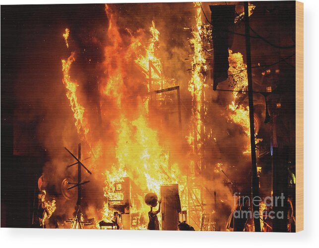 Artist Wood Print featuring the photograph Detail of a Falla Valenciana burning between flames of fire. by Joaquin Corbalan