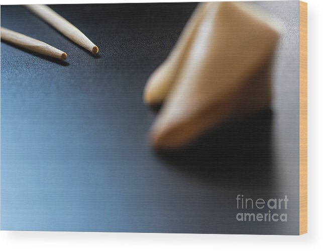Asian Wood Print featuring the photograph Fortune cookies on black background with chopsticks and copy space. by Joaquin Corbalan