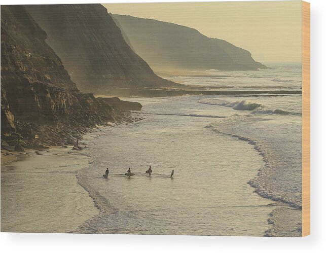 Sea Wood Print featuring the photograph Group Of Surfers Going To Surf In The Ocean At The Sunset. by Cavan Images