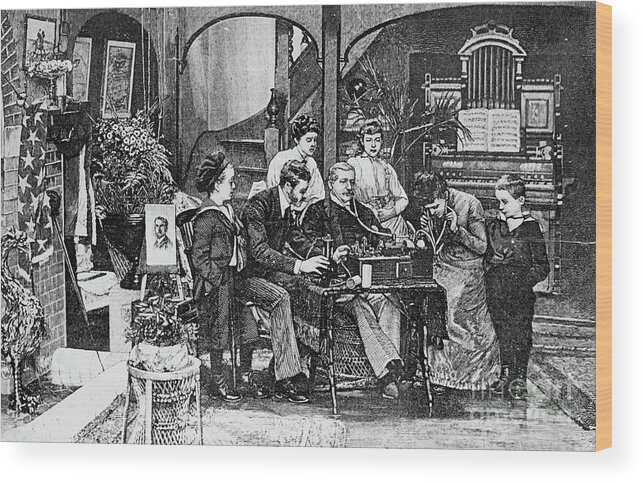 Adjusting Wood Print featuring the photograph Lithograph Of Family Listening To Radio by Bettmann