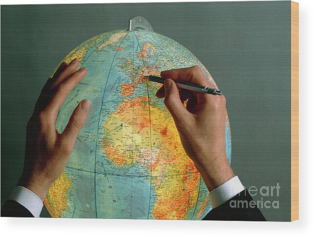 Globe Wood Print featuring the photograph Man Pointing To A Position On A Globe With A Pen by Rosenfeld Images Ltd/science Photo Library