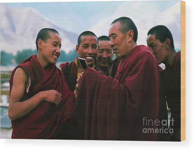 Mature Adult Wood Print featuring the photograph Monks Examining Polaroid Photo by Bettmann