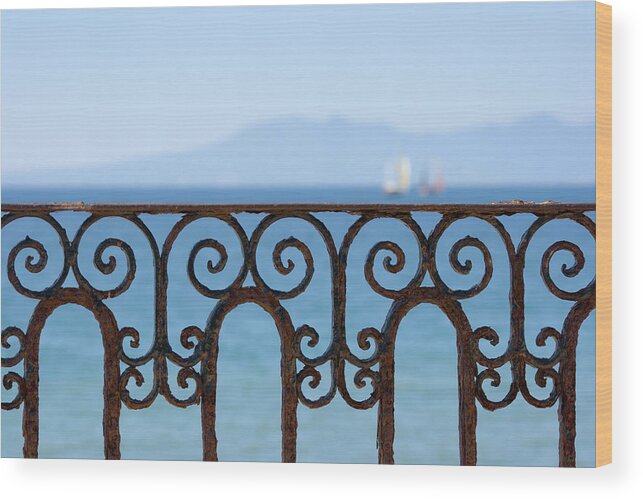 Water's Edge Wood Print featuring the photograph Ornate Ironwork Railing With Ocean View by Yangyin