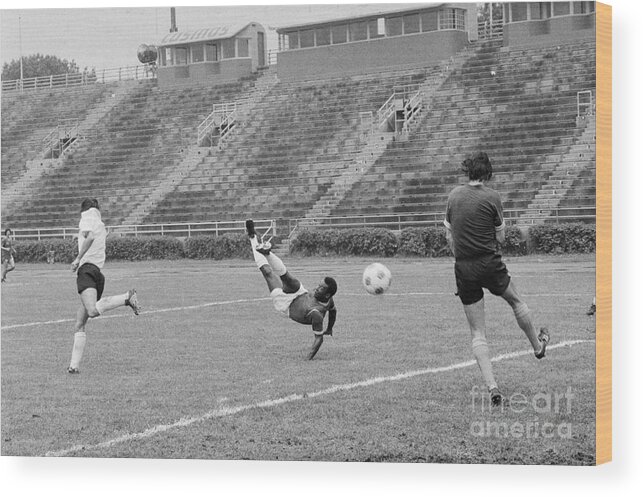 Pelé Wood Print featuring the photograph Pele Performing Tricky Soccer Maneuver by Bettmann