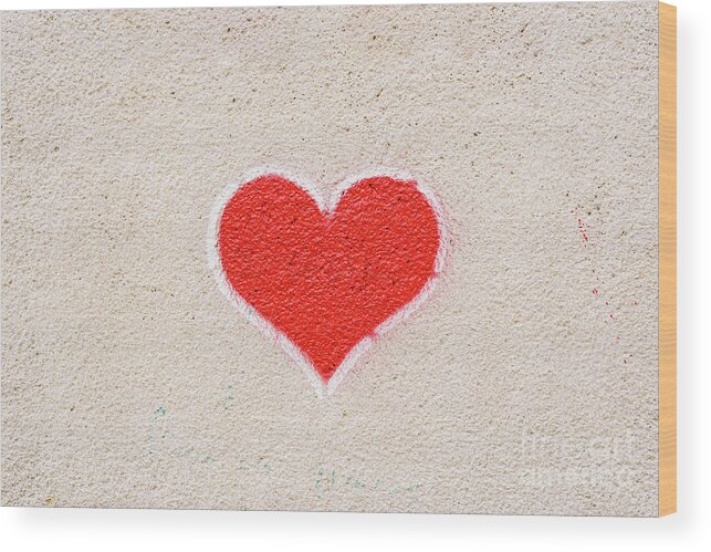 Abstract Wood Print featuring the photograph Red heart painted on a wall, message of love. by Joaquin Corbalan