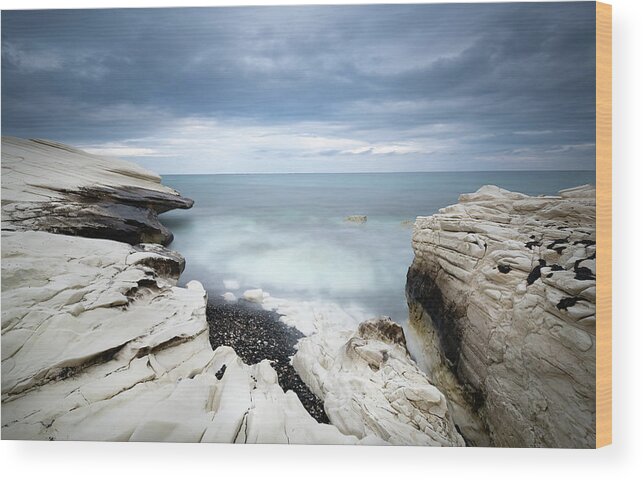 Seascape Wood Print featuring the photograph Rocky coast with white limestones and cloudy sky by Michalakis Ppalis